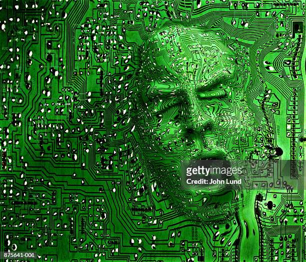 face emerging from circuit board (digital composite) - schocktaktik stock-fotos und bilder