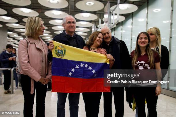 Former mayor of Caracas, Antonio Ledezma holds the Venezuelan flag as he poses for the press with his wife Mitzy Capriles and family at his arrival...
