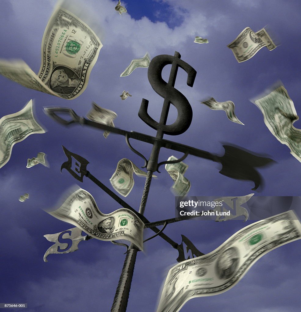 US currency blowing around weather vane (Digital Composite)