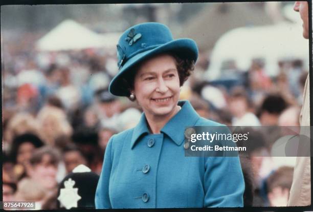 Wearing a blue hat and matching coat, Queen Elizabeth II of England is married to Philip Mountbatten, now Prince Philip The Duke of Edinburgh, and is...