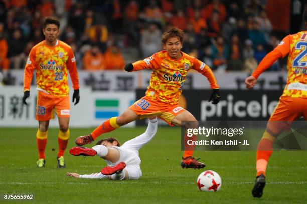 Shota Kaneko of Shimizu S-Pulse is tackled during the J.League J1 match between Shimizu S-Pulse and Consadole Sapporo at IAI Stadium Nihondaira on...