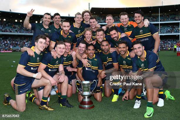 The Australian team pose with the Cormac McAnallen trophy after winning game two and the series of the International Rules Series between Australia...