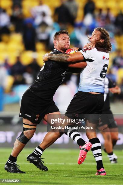 Jared Waerea-Hargreaves of the Kiwis fends off Ashton Sims of Fiji during the 2017 Rugby League World Cup Quarter Final match between New Zealand and...