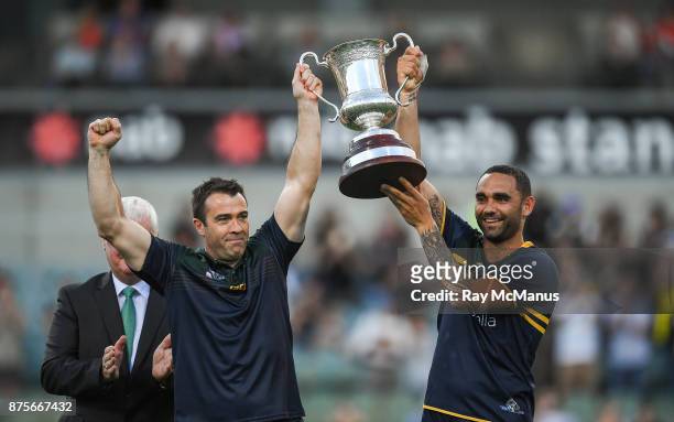 Perth , Australia - 18 November 2017; Australian manager Chris Scott, left, and captain Shaun Burgoyne lift Cormac McAnallen Cup after the Virgin...