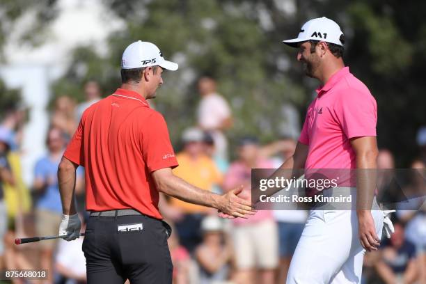 Justin Rose of England is congratulated by Jon Rahm of Spain after his birdie on the 13th green during the third round of the DP World Tour...