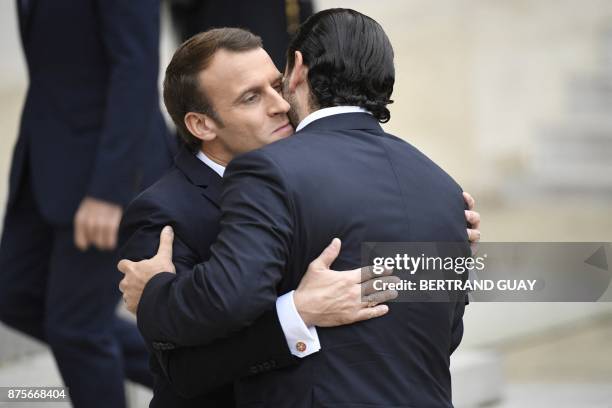 French President Emmanuel Macron embraces Lebanese Prime Minister Saad Hariri at the Elysee Presidential Palace on November 18, 2017 in Paris. Hariri...