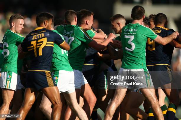 Players from both sides get involved in a melee at the half time break during game two of the International Rules Series between Australia and...