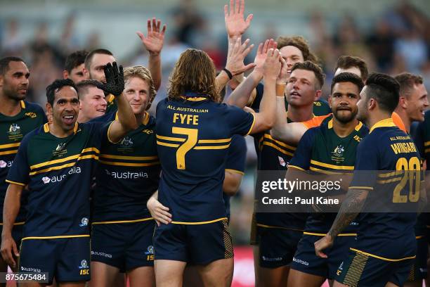 Team mates congratrulate Nathan Fyfe of Australia after being presented player of the series after game two of the International Rules Series between...