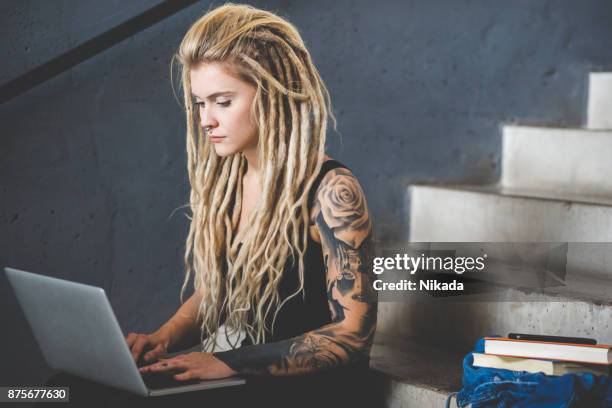 young woman working with laptop - alternative-lifestyle stock pictures, royalty-free photos & images