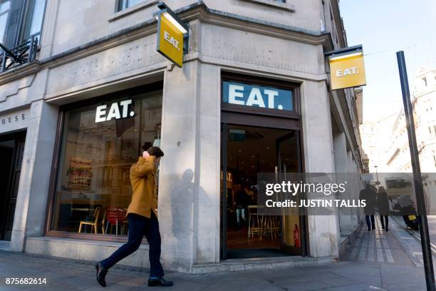 Pedestrian walks pase a branch of an Eat shop in London on November 17, 2017. / AFP PHOTO / Justin TALLIS