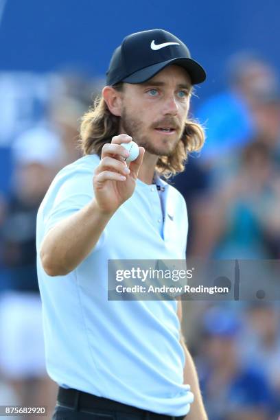 Tommy Fleetwood of England acknowledges the crowd on the 18th hole during the third round of the DP World Tour Championship at Jumeirah Golf Estates...