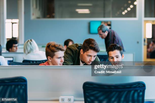 three young men studying, brainstorming or having a business meeting. startup. bring your own device area - apprentice office imagens e fotografias de stock