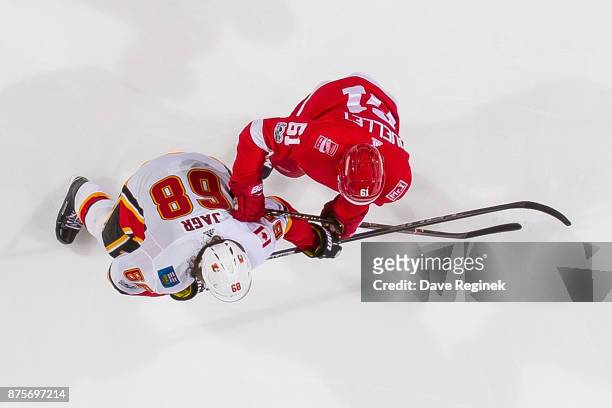 Xavier Ouellet of the Detroit Red Wings battles for position with Jaromir Jagr of the Calgary Flames during an NHL game at Little Caesars Arena on...