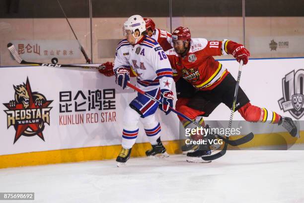 Brandon Yip of HC Kunlun Red Star and Sergei Plotnikov of SKA Saint Petersburg vie for the puck during the 2017/18 Kontinental Hockey League Regular...