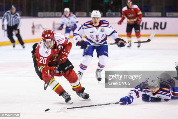 Lucas Lockhart of HC Kunlun Red Star and Dinar Khafizullin of SKA Saint Petersburg vie for the puck during the 2017/18 Kontinental Hockey League...