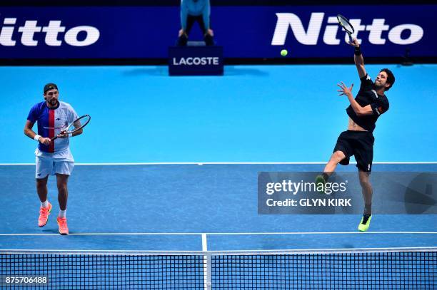 Brazil's Marcelo Melo returns as his partner Poland's Lukasz Kubot stands ready against US player Ryan Harrison and New Zealand's Michael Venus...