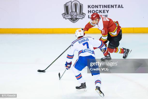 Marek Daloga of HC Kunlun Red Star and David Rundblad of SKA Saint Petersburg vie for the puck during the 2017/18 Kontinental Hockey League Regular...