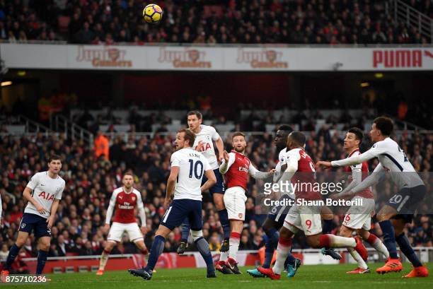 Shkodran Mustafi of Arsenal scores his sides first goal during the Premier League match between Arsenal and Tottenham Hotspur at Emirates Stadium on...