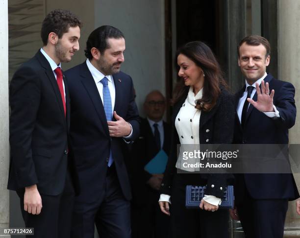 French President Emmanuel Macron R) welcomes Lebanese Prime Minister Saad Hariri and his wife Lara and their son Hussam at the Elysee Palace in...