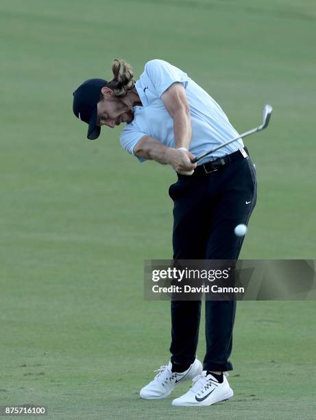 Tommy Fleetwood of England plays his second shot on the 18th hole during the third round of the 2017 DP World Tour Championship on the Earth Course...