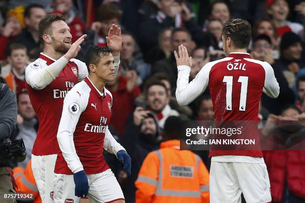 Arsenal's German defender Shkodran Mustafi celebrates scoring the team's first goal with Arsenal's Chilean striker Alexis Sanchez and Arsenal's...