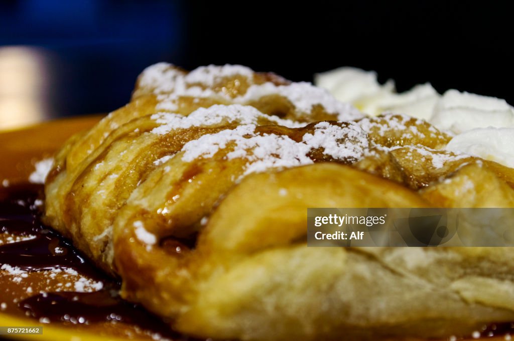 Puff pastry stuffed with cream with raspberry sauce