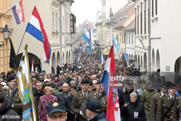 People march in Vukovar on November 18 during a ceremony to mark the 26th anniversary of the fall of Vukovar to Serb forces, the bloodiest episode of...