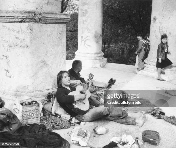 Urban vagrants in Munich, lazing around at the Monopteros at Englischer Garten