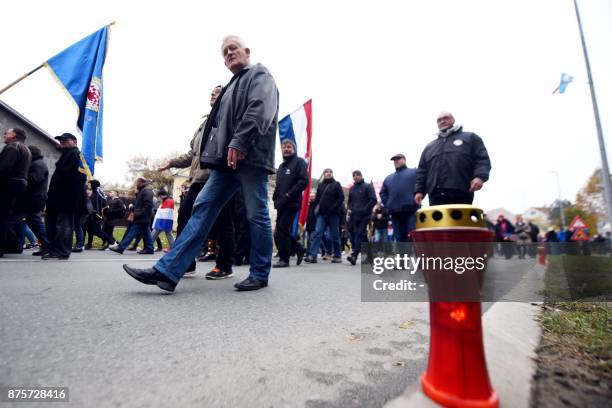 People pass a candle lit as part a ceremony to mark the 26th anniversary of the fall of Vukovar to Serb forces, the bloodiest episode of Croatia's...