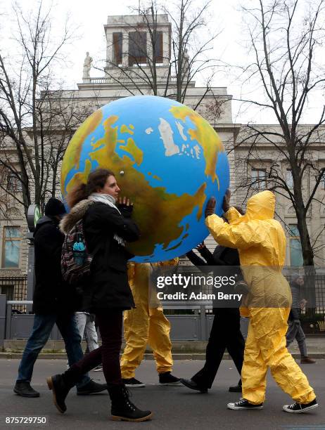Activists march with an inflatable globe during a demonstration against nuclear weapons on November 18, 2017 in Berlin, Germany. About 700...
