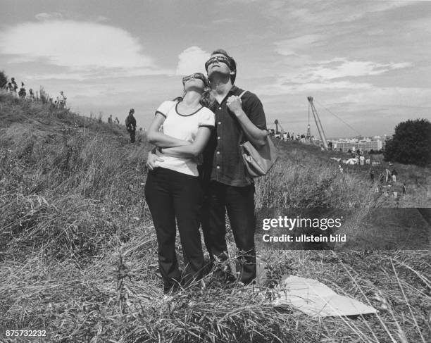Munich, couple watching the solar eclipse in the Olympic area