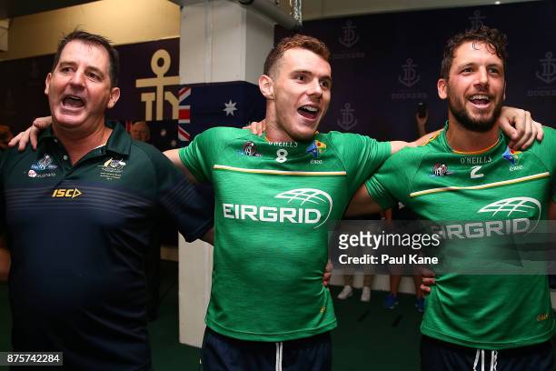 Ross Lyon, Luke Shuey and Travis Boak of Australia celebrate after winning game two and the series of the International Rules Series between...