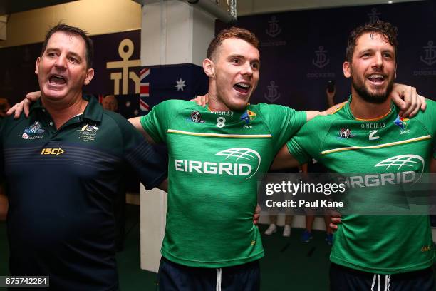 Ross Lyon, Luke Shuey and Travis Boak of Australia celebrate after winning game two and the series of the International Rules Series between...