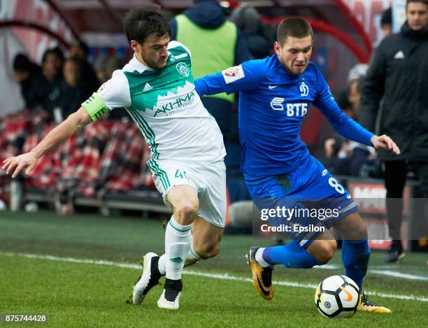 Aleksandr Tashayev of FC Dinamo Moscow vies for the ball with Rizvan Utsiyev of FC Akhmat Grozny during the Russian Premier League match between FC...