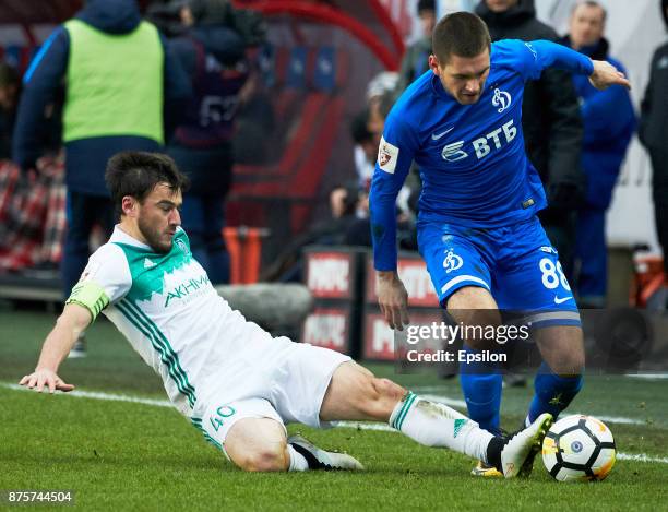 Aleksandr Tashayev of FC Dinamo Moscow vies for the ball with Rizvan Utsiyev of FC Akhmat Grozny during the Russian Premier League match between FC...