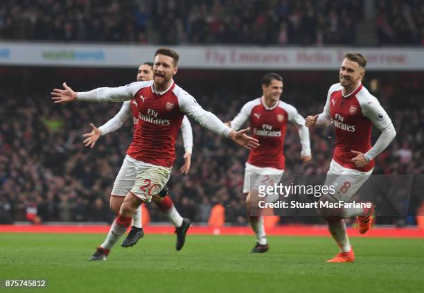 Shkodran Mustafi celebrates scoring the first Arsenal goal with Aaron Ramsey during the Premier League match between Arsenal and Tottenham Hotspur at...
