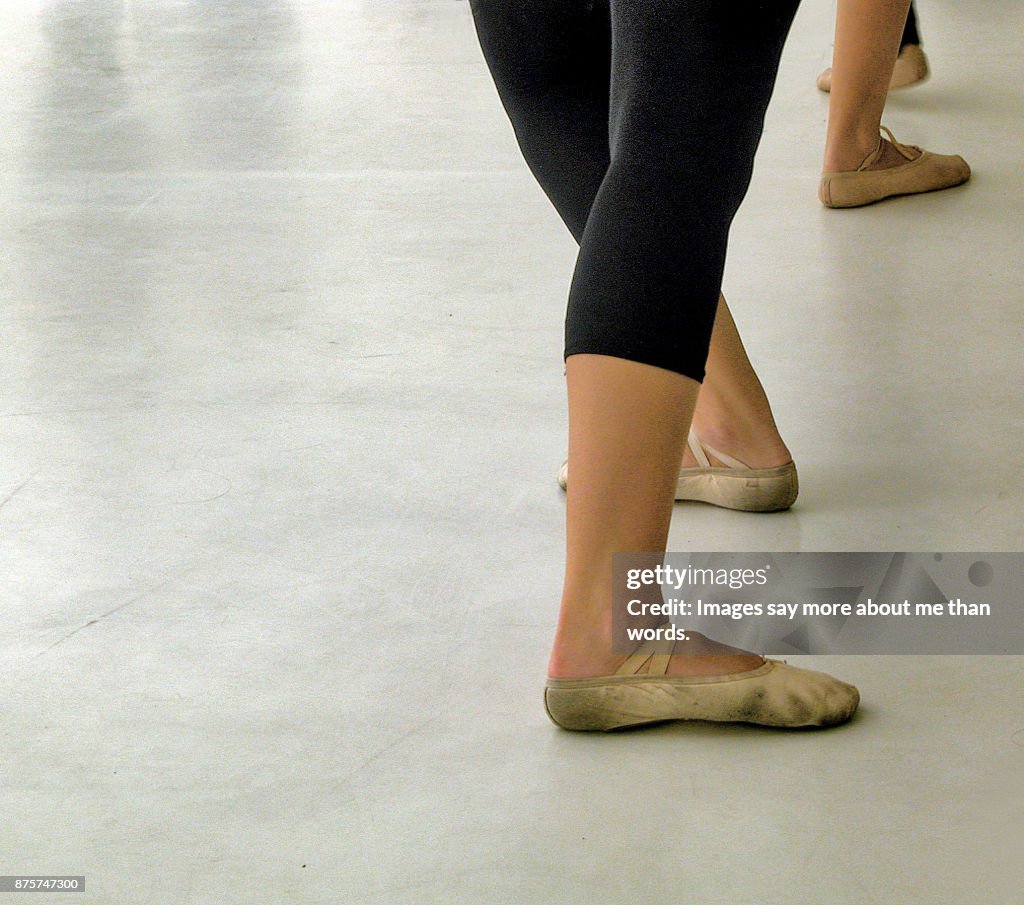 Close up of the feet of rehearsing ballerinas.