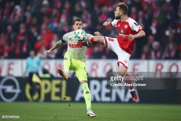 Simon Zoller of Koeln is challenged by Alexandru Maxim of Mainz during the Bundesliga match between 1. FSV Mainz 05 and 1. FC Koeln at Opel Arena on...