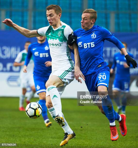 Nikolay Obolskiy of FC Dinamo Moscow vies for the ball with Andrei Semyonov of FC Akhmat Grozny during the Russian Premier League match between FC...