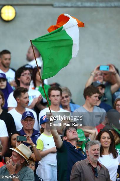 An Irish fan waves his flag during game two of the International Rules Series between Australia and Ireland at Domain Stadium on November 18, 2017 in...