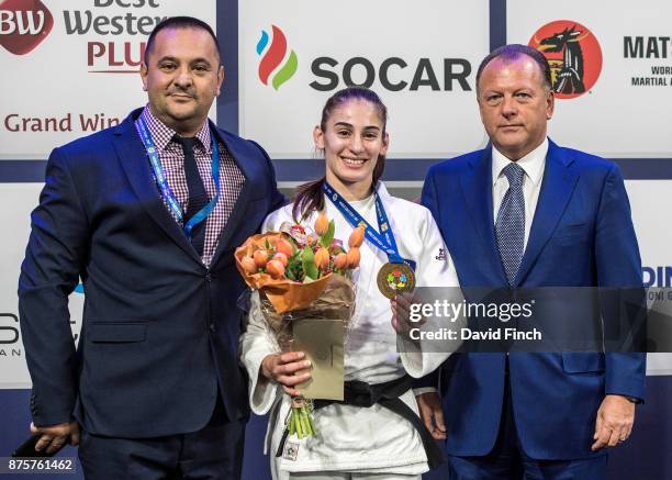 Kosovo's judo coach, Driton Kuka, proudly stands alongside Kosovo's u57kg gold medalist Nora Gjakova together with the International Judo...