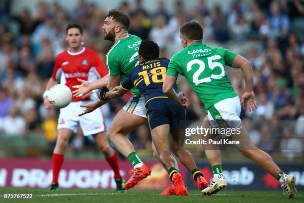 Aidan O'Shea of Ireland gets his hand pass away while being tackled by Eddie Betts of Australia during game two of the International Rules Series...