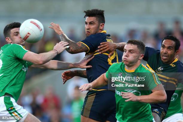 Brendan Harrison and Sean Powter of Ireland contest for the ball against Chad Wingard and Eddie Betts of Australia during game two of the...