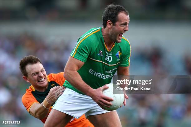 Michael Murphy of Ireland looks to break from a tackle by Brendon Goddard of Australia during game two of the International Rules Series between...
