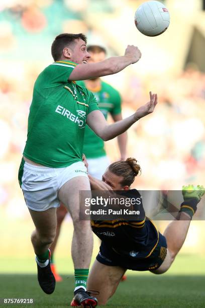 Conor Sweeney of Ireland looks to hand pass while being tackled by Nathan Fyfe of Australia during game two of the International Rules Series between...
