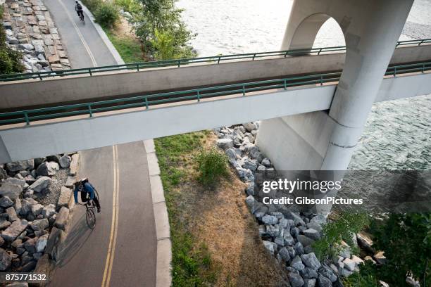 bicycle messenger - calgary bridge stock pictures, royalty-free photos & images