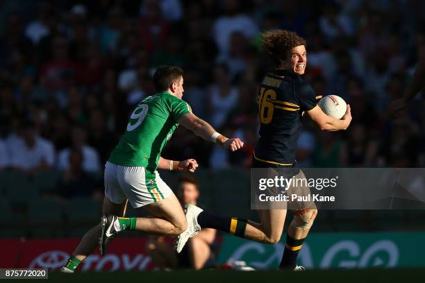 Ben Brown of Australia runs clear of Paul Geaney of Ireland during game two of the International Rules Series between Australia and Ireland at Domain...