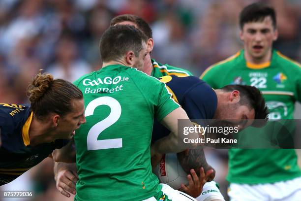 Chad Wingard of Australia gets tackled by Chris Barrett of Ireland during game two of the International Rules Series between Australia and Ireland at...