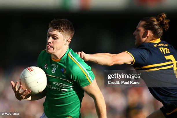 Kevin Feely of Ireland looks to break from a tackled by Nathan Fyfe of Australia during game two of the International Rules Series between Australia...