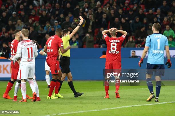 Benjamin Henrichs of Bayer Leverkusen receives a red card from referee Harm Osmers during the Bundesliga match between Bayer 04 Leverkusen and RB...